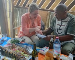 Sara deeply enjoying her welcoming meal in Bangui (with Bernard Simiti)