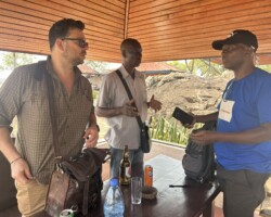 Peter Coutros, Henri Zana, and Lucien Pierre Nguerede discussing their imminent terrestrial mission in northwest CAR